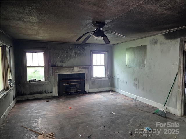 721 S Spruce St, Rock Hill, SC 29730 - unfurnished living room with a glass covered fireplace, ceiling fan, and unfinished concrete floors