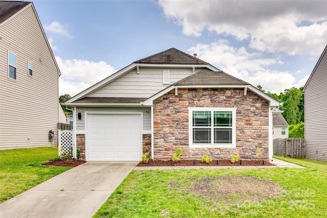 craftsman-style home featuring fence, an attached garage, stone siding, a front yard, and concrete driveway
