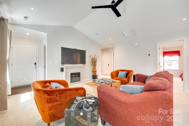 living room featuring visible vents, a fireplace, light colored carpet, a ceiling fan, and vaulted ceiling