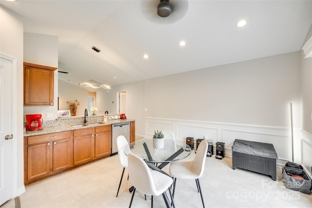 dining area with a ceiling fan, vaulted ceiling, a wainscoted wall, a decorative wall, and recessed lighting