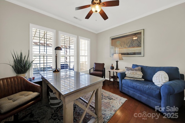 office area with ornamental molding, a ceiling fan, visible vents, and wood finished floors