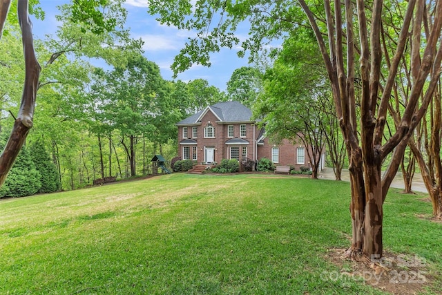 colonial house with brick siding and a front lawn