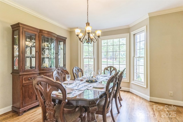 dining space with baseboards, a notable chandelier, and a wealth of natural light
