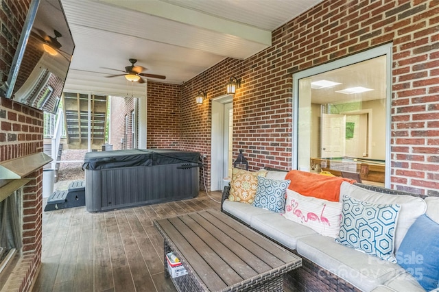 wooden terrace with an outdoor hangout area, ceiling fan, and a hot tub