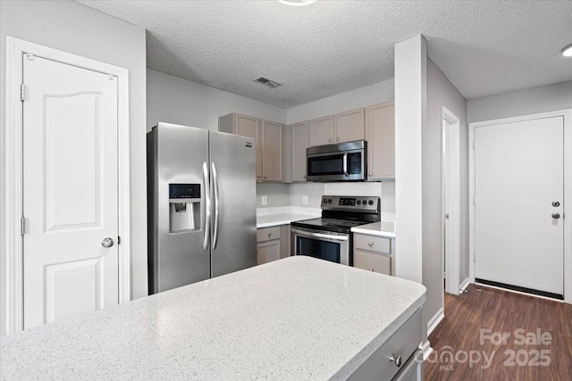 kitchen featuring visible vents, gray cabinetry, stainless steel appliances, light countertops, and dark wood-style floors