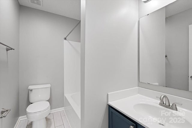full bath with vanity, toilet, visible vents, baseboards, and shower / washtub combination