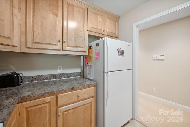 108 Ivy Ct, Morganton, NC 28655 - kitchen with freestanding refrigerator, dark countertops, and light brown cabinets