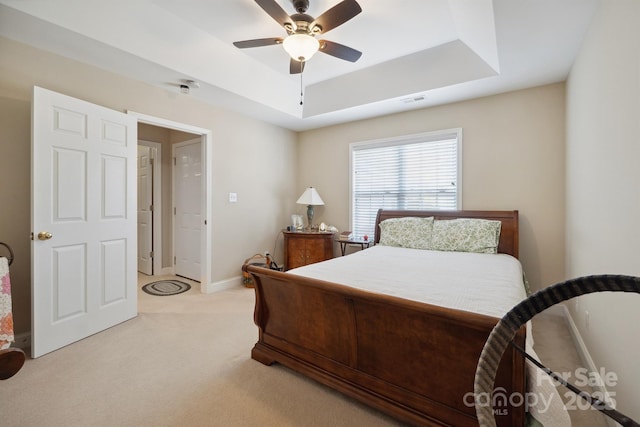 108 Ivy Ct, Morganton, NC 28655 - bedroom with visible vents, light carpet, baseboards, a tray ceiling, and a ceiling fan