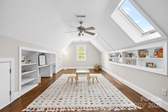 18730 Floyd Ct, Davidson, NC 28036 - playroom featuring vaulted ceiling, a skylight, dark wood finished floors, ceiling fan, and built in shelves