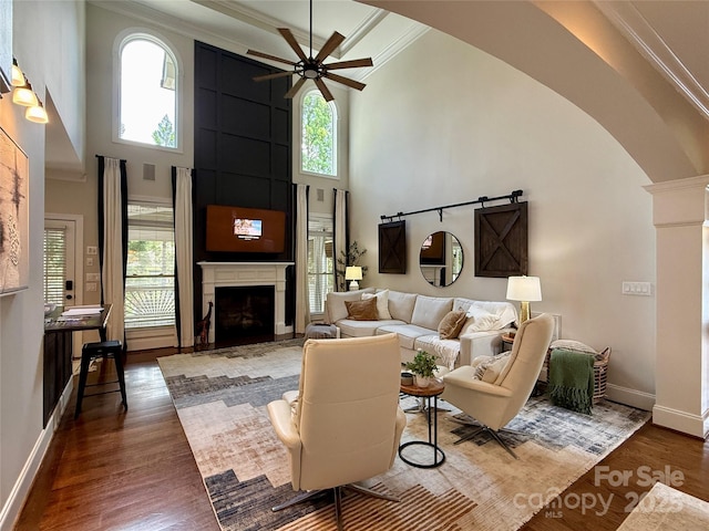 18730 Floyd Ct, Davidson, NC 28036 - living area featuring arched walkways, a high ceiling, ceiling fan, wood finished floors, and crown molding