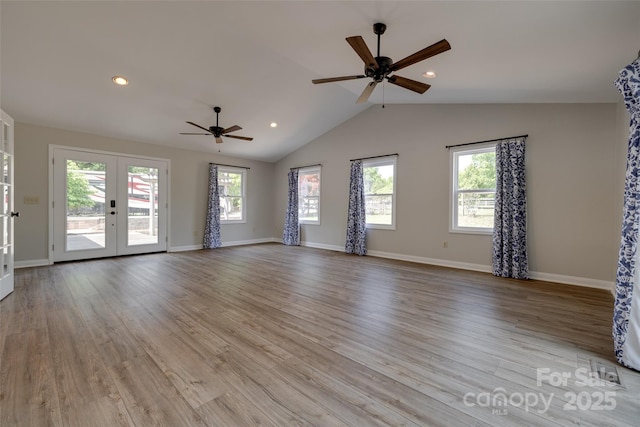 unfurnished living room featuring ceiling fan, a wealth of natural light, french doors, and lofted ceiling