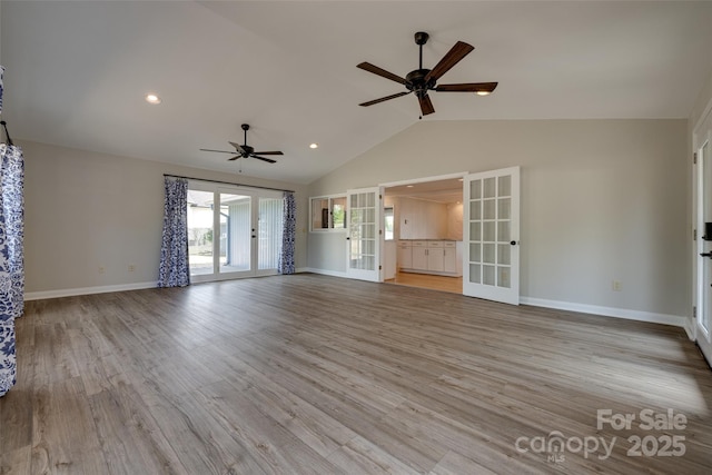unfurnished living room featuring baseboards, a ceiling fan, and lofted ceiling