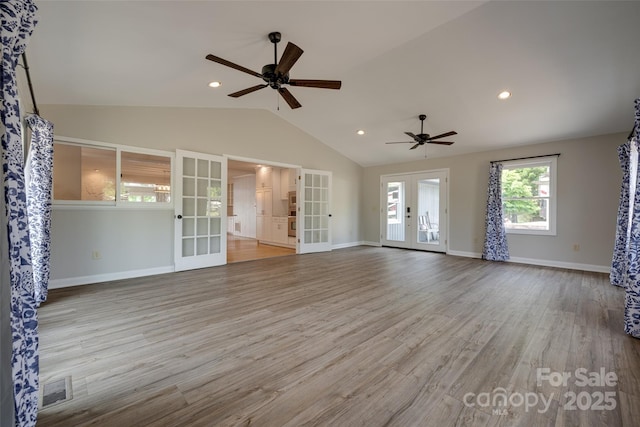 unfurnished living room with a ceiling fan, visible vents, french doors, and lofted ceiling