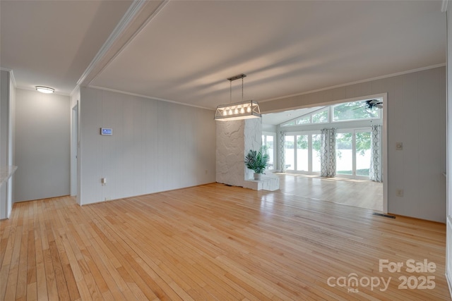 unfurnished room featuring ornamental molding, light wood finished floors, and visible vents