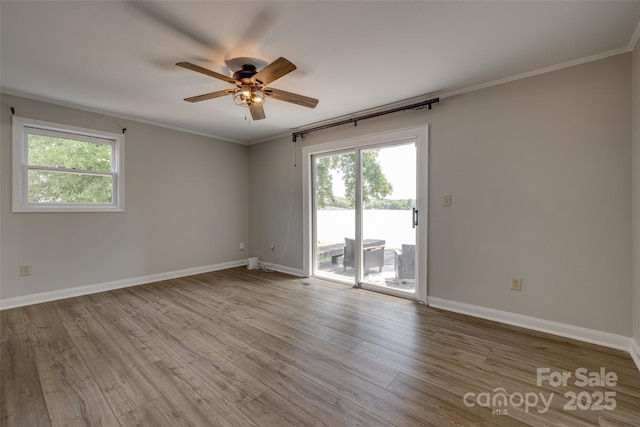 unfurnished room with baseboards, a ceiling fan, and wood finished floors