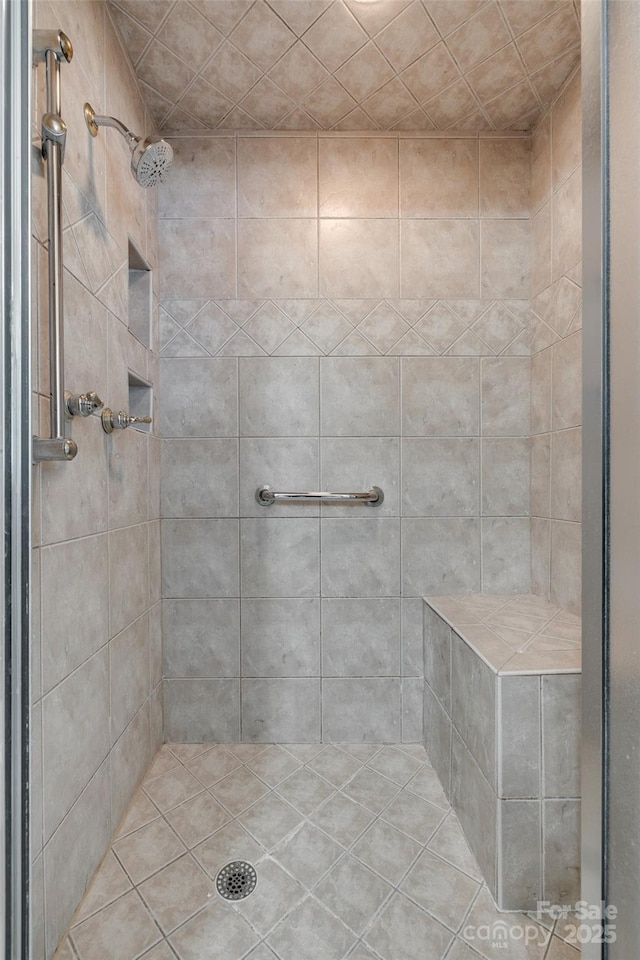 bathroom with tiled shower