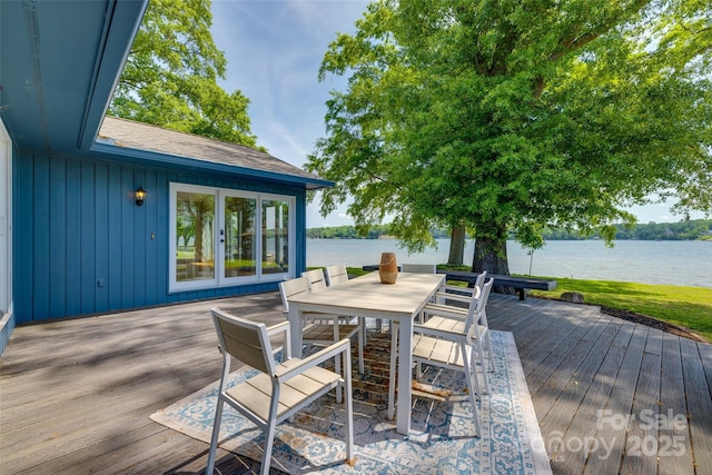deck featuring a water view and outdoor dining space