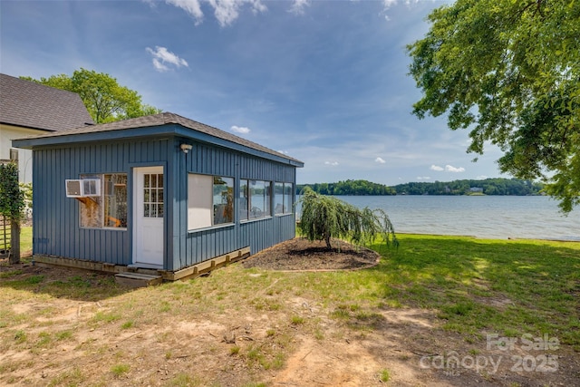 exterior space with a water view and a wall mounted AC