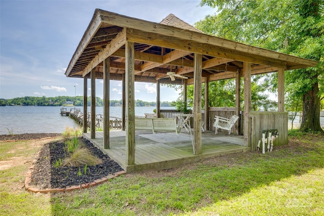 dock area with a gazebo and a deck with water view