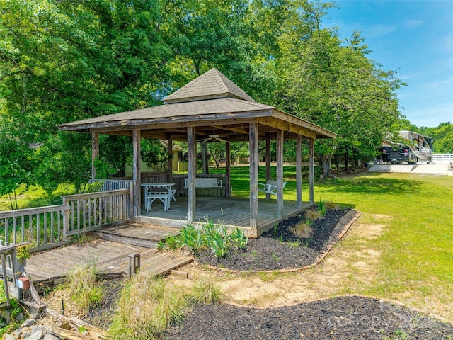 surrounding community with a lawn, a wooden deck, and a gazebo