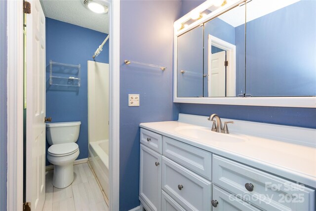bathroom featuring vanity, bathing tub / shower combination, and toilet