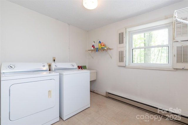 washroom with washer and dryer, laundry area, and a baseboard radiator