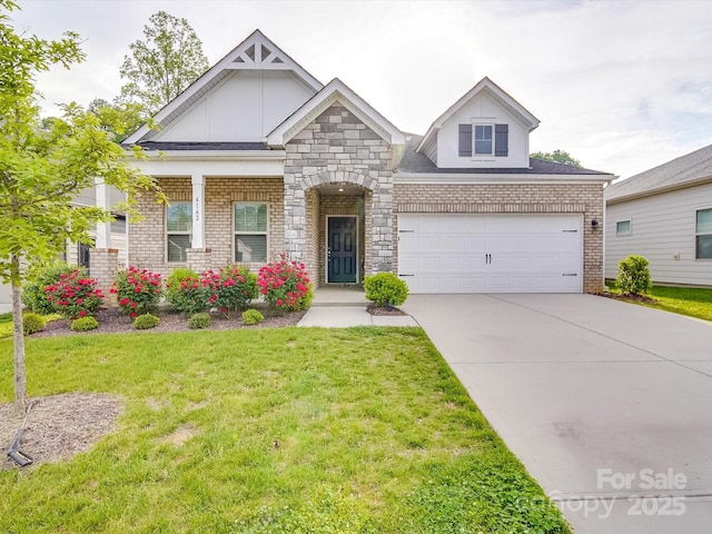 craftsman house featuring a garage, a front yard, and concrete driveway