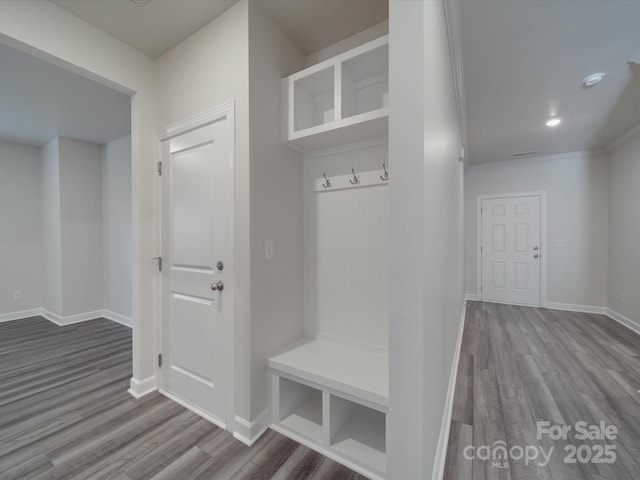mudroom featuring recessed lighting, baseboards, ornamental molding, and wood finished floors