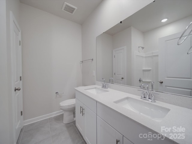 full bathroom featuring walk in shower, visible vents, and a sink