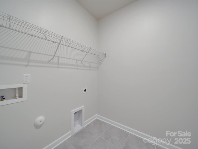 clothes washing area with laundry area, tile patterned flooring, baseboards, hookup for a washing machine, and hookup for an electric dryer