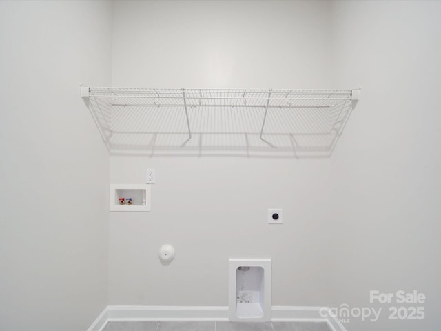 laundry area with laundry area, hookup for a gas dryer, baseboards, washer hookup, and hookup for an electric dryer