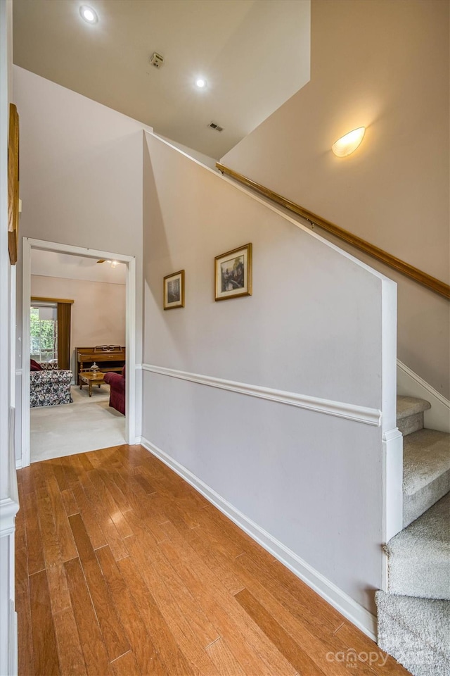 interior space featuring recessed lighting, wood finished floors, stairs, baseboards, and visible vents