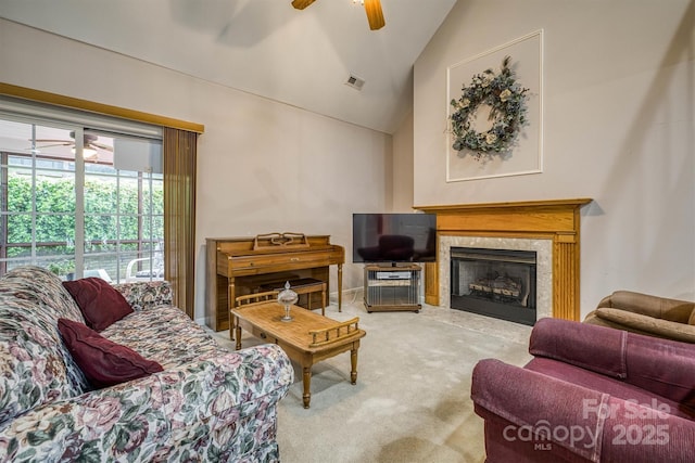 carpeted living area with a fireplace, ceiling fan, high vaulted ceiling, and visible vents