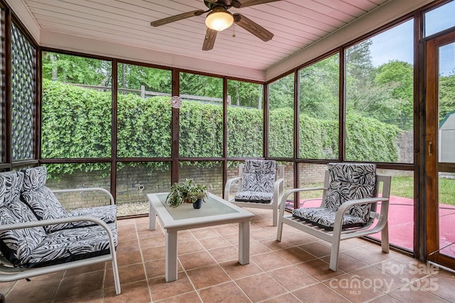 sunroom with a ceiling fan