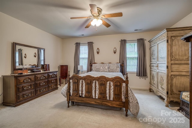 bedroom featuring visible vents, a ceiling fan, and light carpet