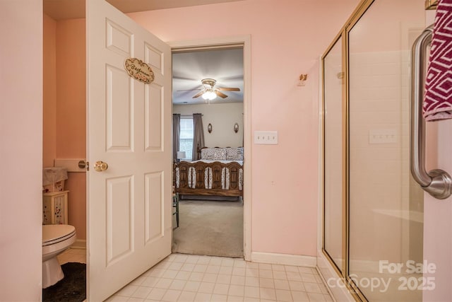 bathroom featuring tile patterned flooring, ceiling fan, toilet, ensuite bathroom, and a stall shower
