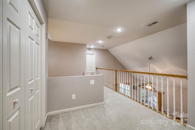 hallway featuring recessed lighting, carpet floors, vaulted ceiling, baseboards, and visible vents