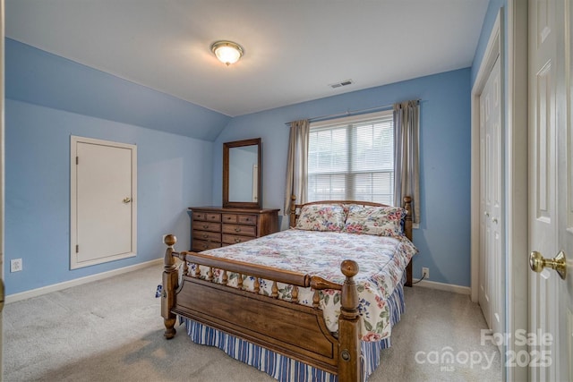 bedroom with baseboards, visible vents, light carpet, and lofted ceiling