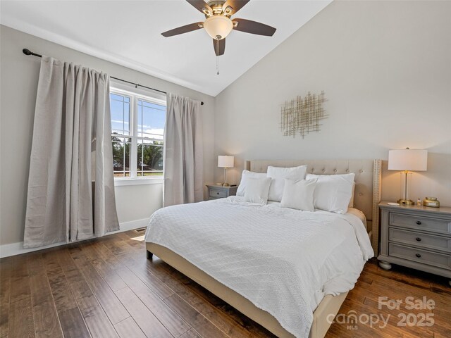 bedroom featuring lofted ceiling, a ceiling fan, baseboards, and wood finished floors