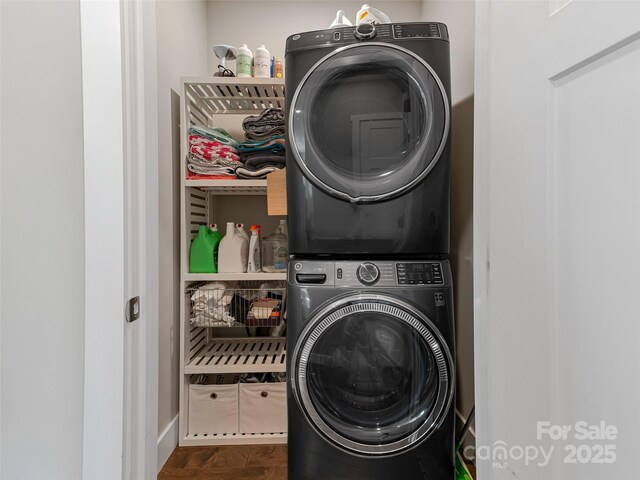 washroom featuring stacked washer and dryer and laundry area