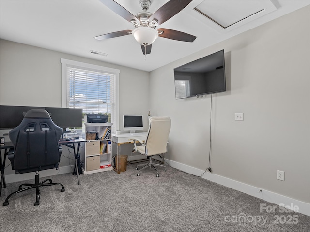 carpeted office featuring baseboards, a ceiling fan, and visible vents