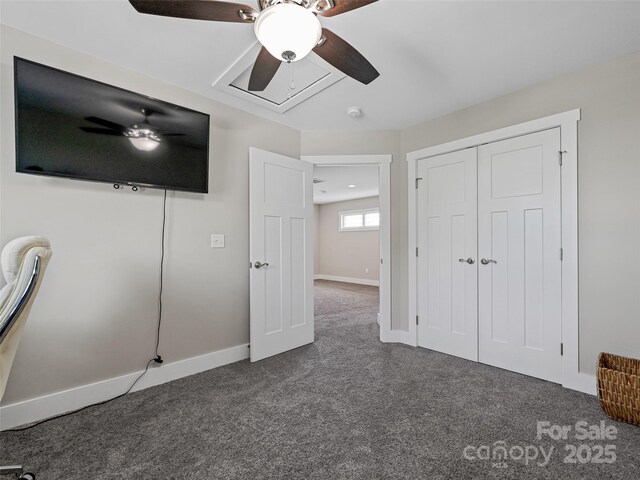 unfurnished bedroom with dark carpet, ceiling fan, baseboards, and a closet