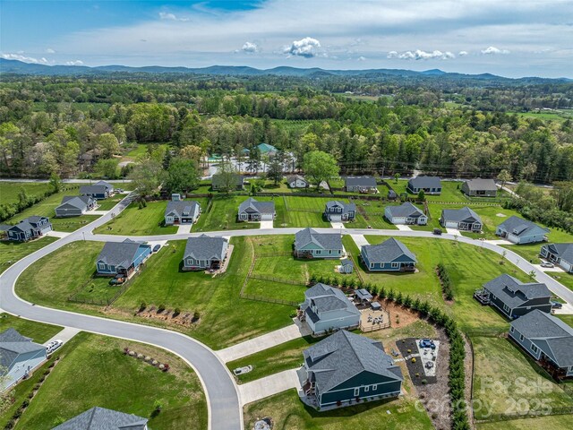 aerial view with a residential view, a wooded view, and a mountain view