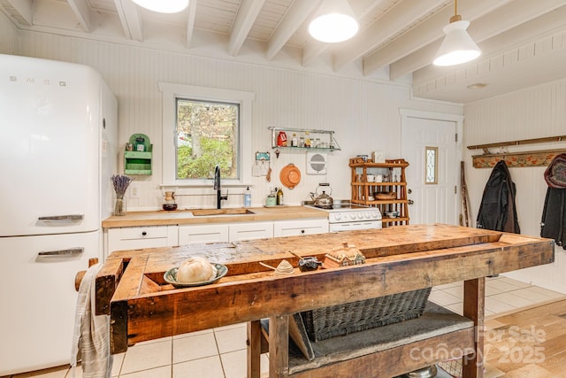19 Castle St, Asheville, NC 28803 - kitchen featuring a sink, white appliances, wood counters, white cabinetry, and beam ceiling