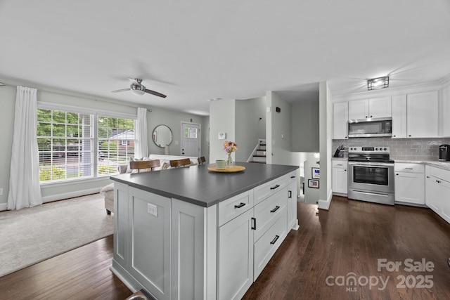 2100 Shadyview Dr, Charlotte, NC 28210 - kitchen with appliances with stainless steel finishes, ceiling fan, dark wood finished floors, and white cabinetry