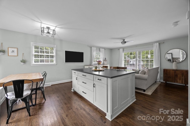 2100 Shadyview Dr, Charlotte, NC 28210 - kitchen with dark countertops, open floor plan, white cabinetry, and dark wood-style floors
