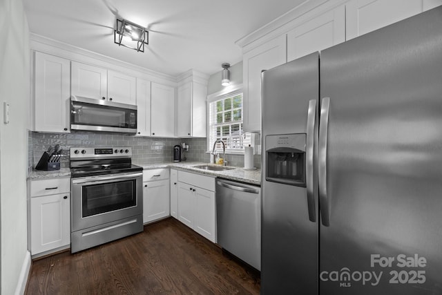 2100 Shadyview Dr, Charlotte, NC 28210 - kitchen featuring stainless steel appliances, a sink, dark wood-style flooring, backsplash, and white cabinets