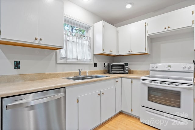 kitchen featuring electric range, a toaster, light countertops, a sink, and dishwasher