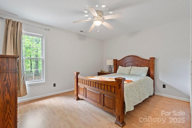 bedroom featuring baseboards, a ceiling fan, light wood-style flooring, and visible vents