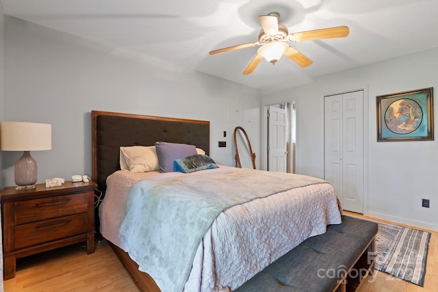 bedroom with a closet, light wood finished floors, and ceiling fan
